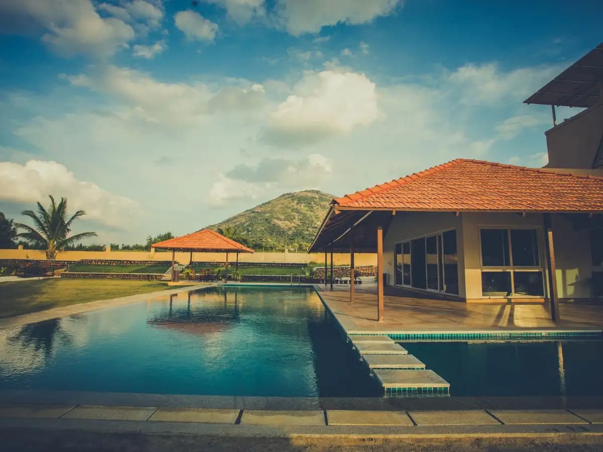 Pool and tiled-roof cottages at Aeon Root Bridges, a Tripture villa